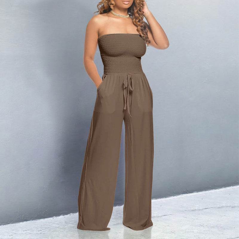 Model in a white off-shoulder wide-leg jumpsuit styled with strappy heels for a summer look
