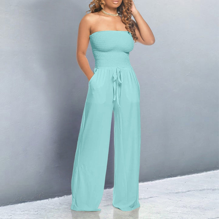 Back view of the flowing wide-leg jumpsuit in beige showing relaxed silhouette