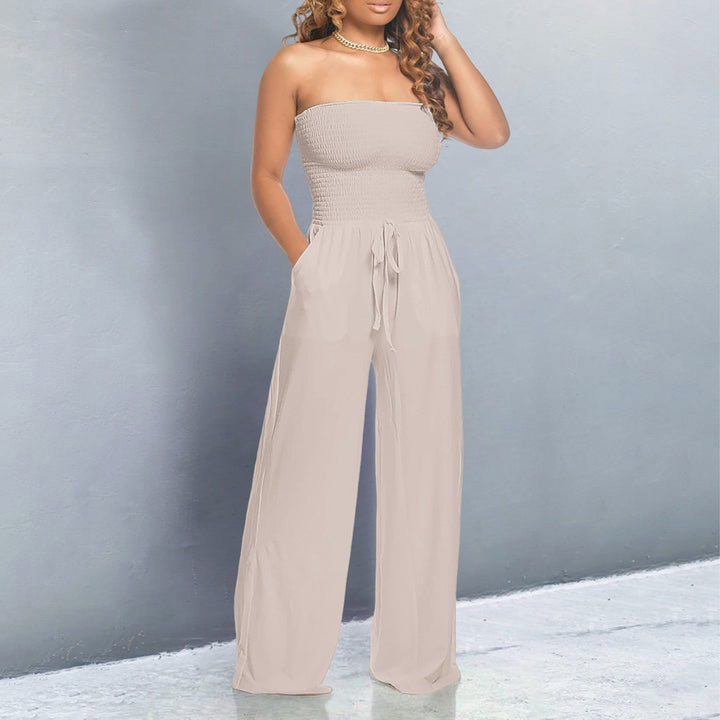 Model wearing a black off-shoulder jumpsuit with wide-leg pants, styled for a night out