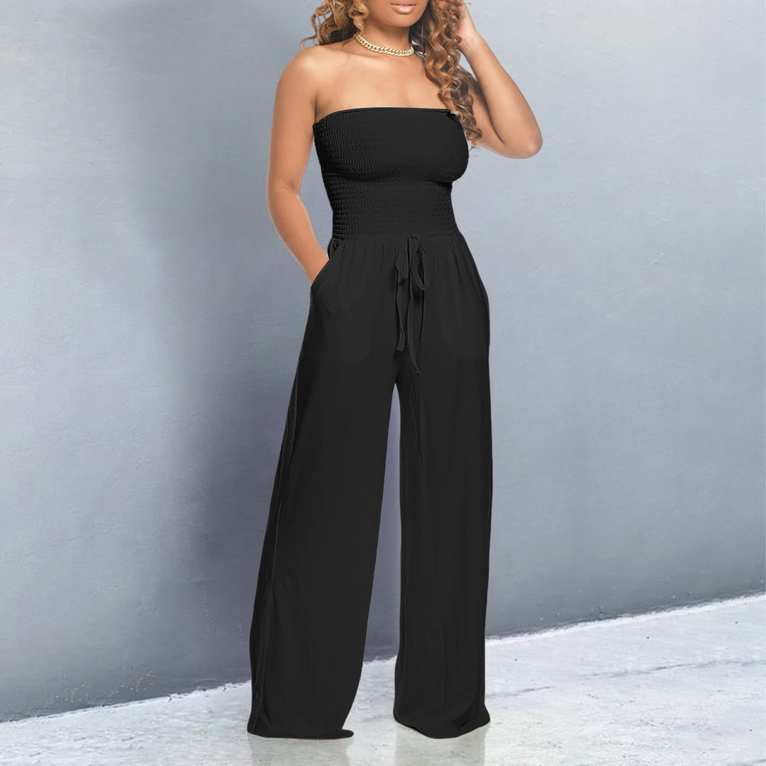 Detail shot of the lightweight fabric and wide-leg hem of the off-shoulder jumpsuit in blue