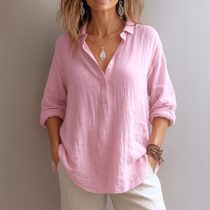 Woman wearing a light airy V-neck blouse in a soft pastel color, styled casually for a warm-weather day