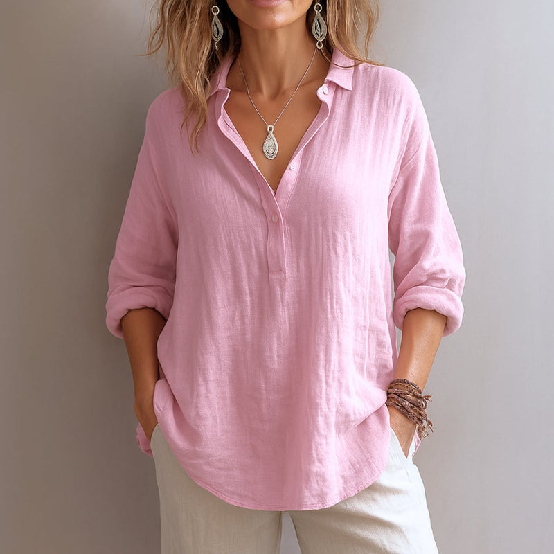 Woman wearing a light airy V-neck blouse in a soft pastel color, styled casually for a warm-weather day