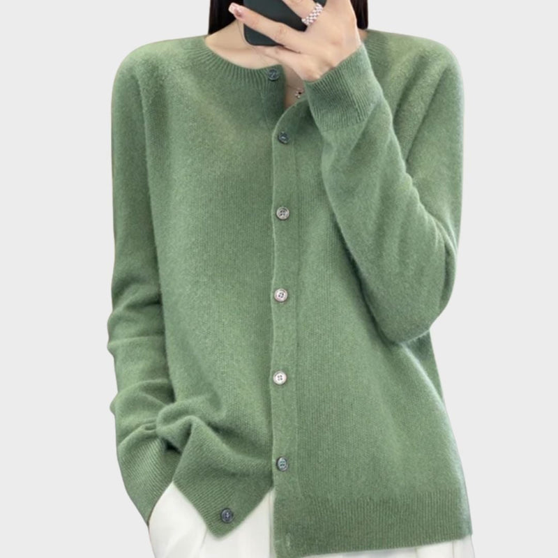 Model wearing a soft, relaxed-fit Bella cardigan in a neutral tone, styled over a simple outfit for a polished everyday look