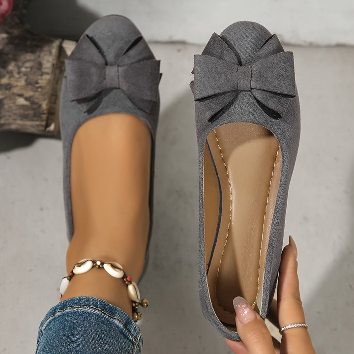 Black bow detail ballet flat, front view showing rounded toe silhouette
