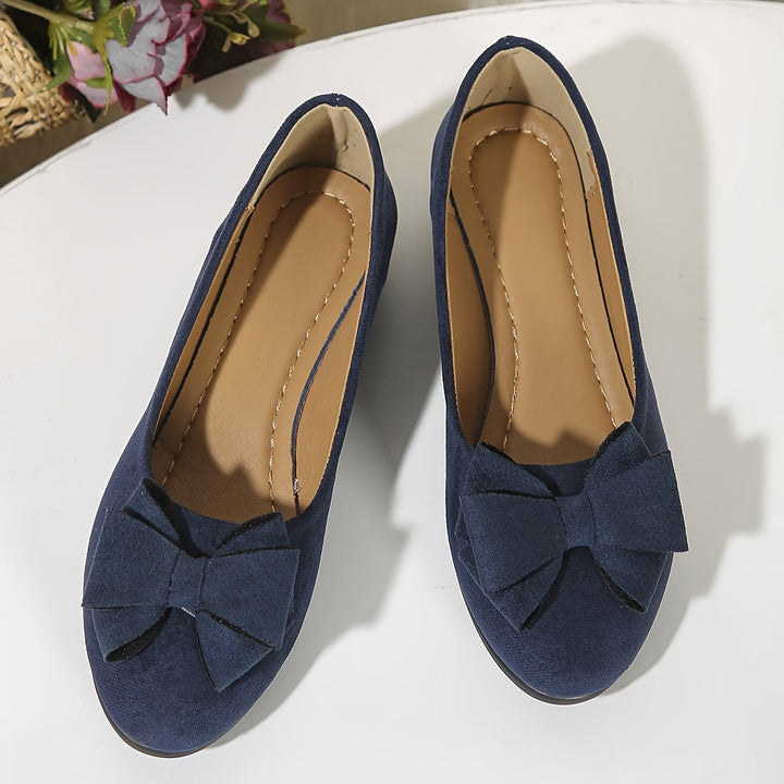 Brown suede-look ballet flat with structured bow detail, side view