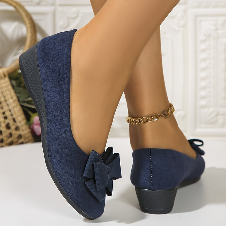 Pair of Bella round toe ballet flats in blue, three-quarter angle view