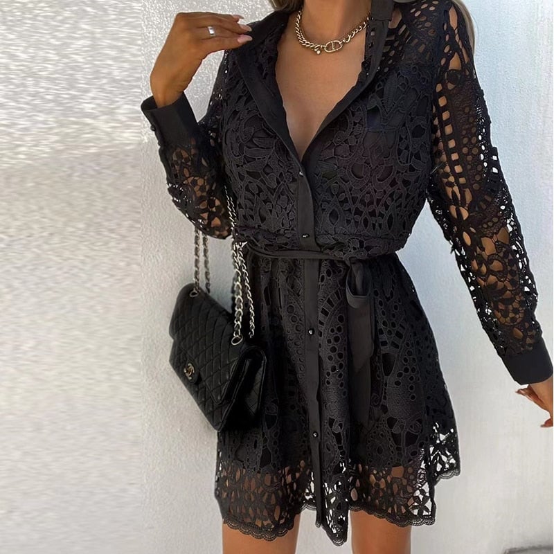 Front view of the Bella black lace mini dress showing the deep V-neck and cinched belted silhouette