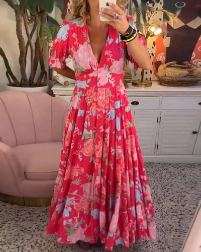 Woman wearing a green flowy maxi dress with a softly cinched waist, shown in a full-length front view