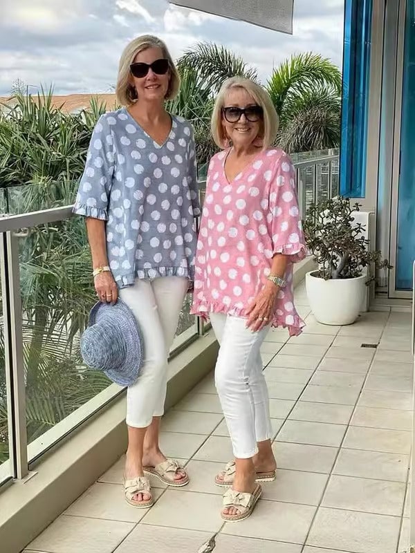 Close-up of the polka dot fabric and V-neckline on the Beth blouse in sky blue