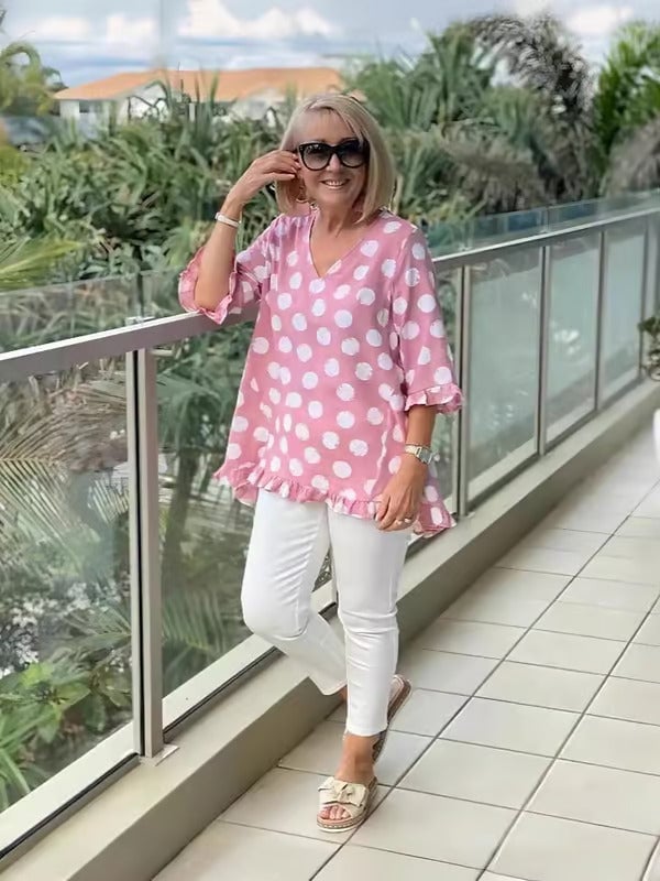 Model styling the Beth polka dot blouse with casual bottoms for an everyday look