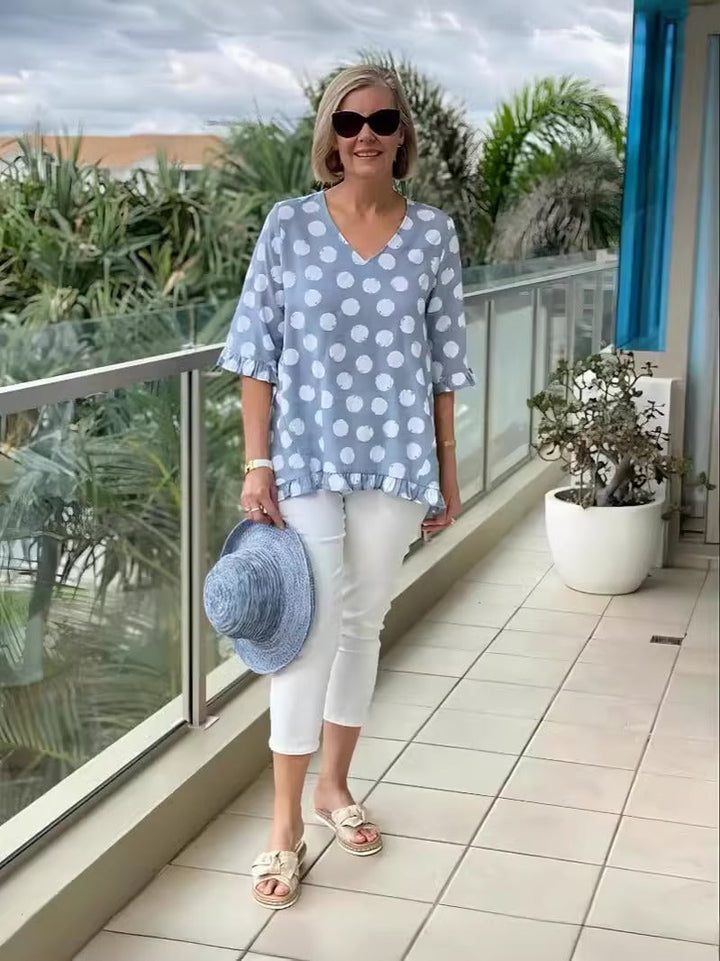Side profile of the Beth V-neck blouse showing the relaxed silhouette and airy fit