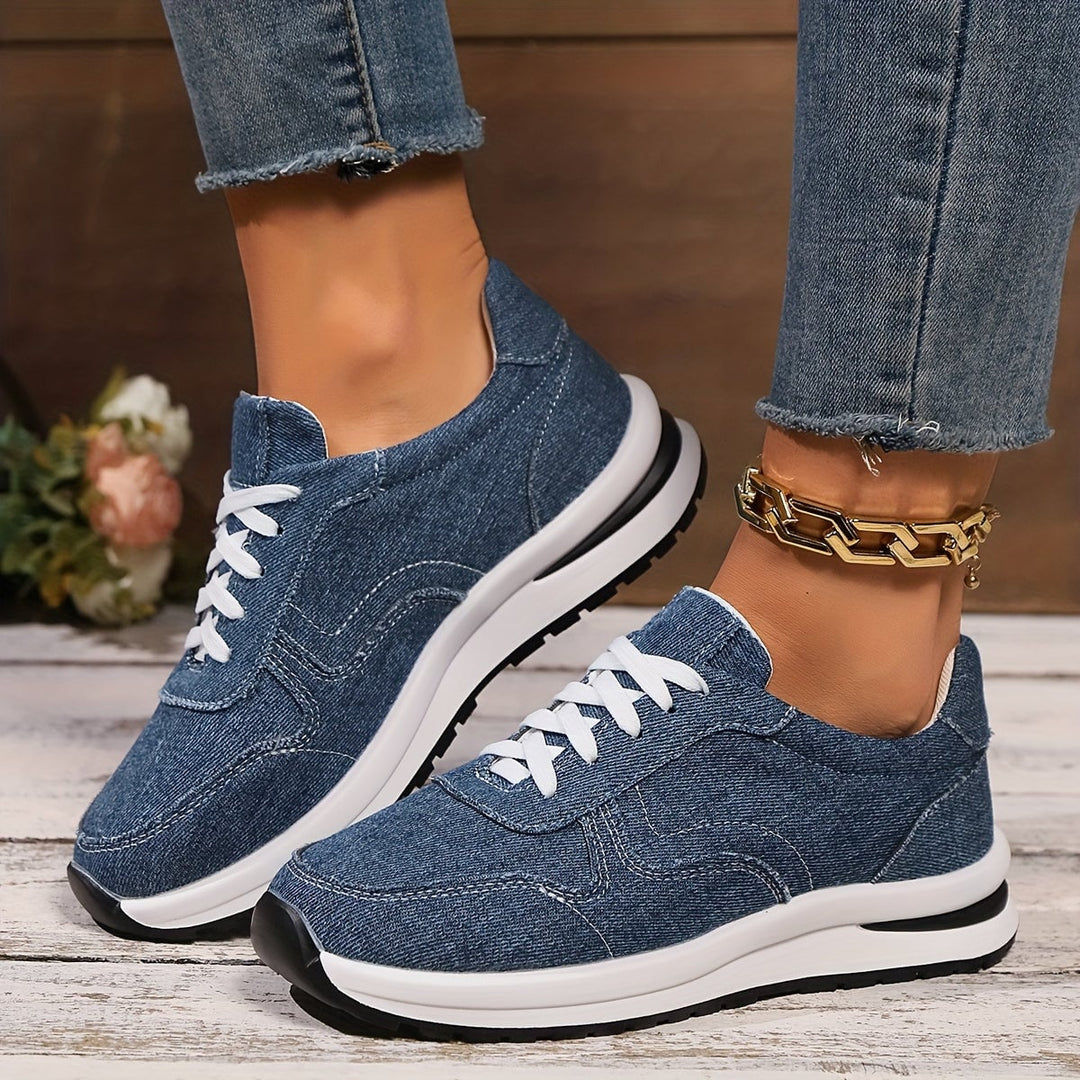 Front view of blue denim orthopedic sneakers with wide toe box and cushioned sole