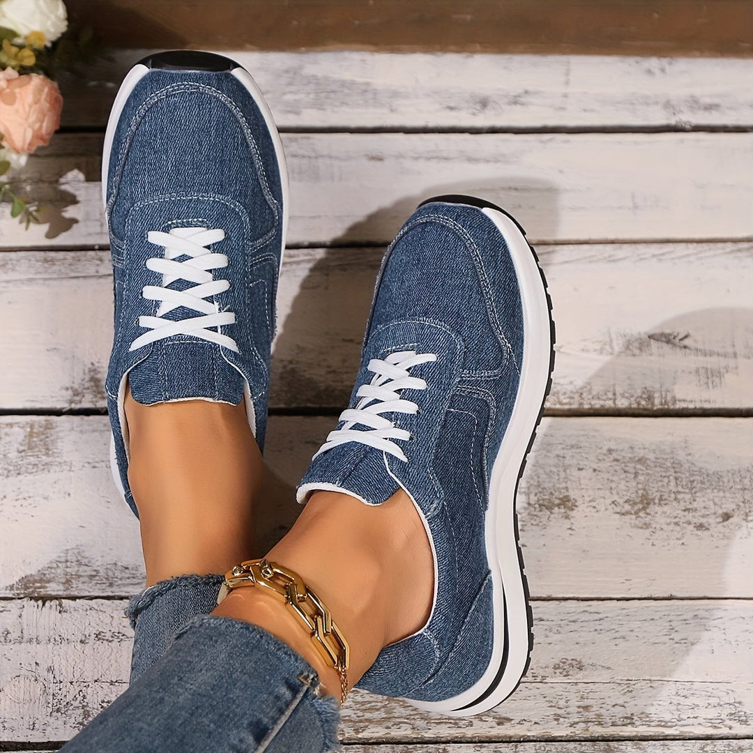 Side profile of women's blue denim orthopedic sneakers showing arch support construction
