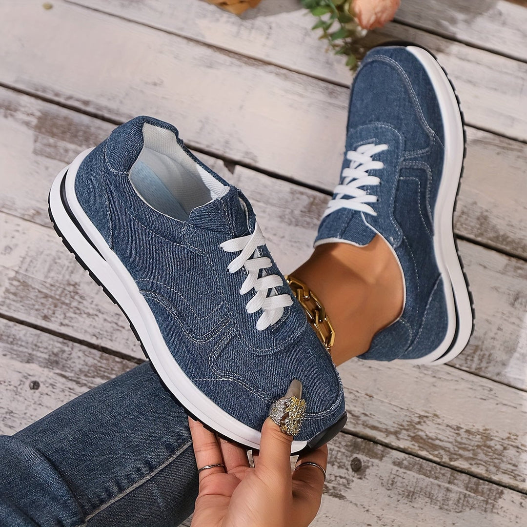 Close-up of the cushioned ergonomic sole on blue denim orthopedic sneakers