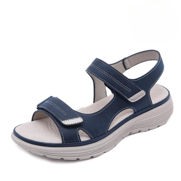Black orthopedic sandal with wide toe box and cushioned sole on a white background