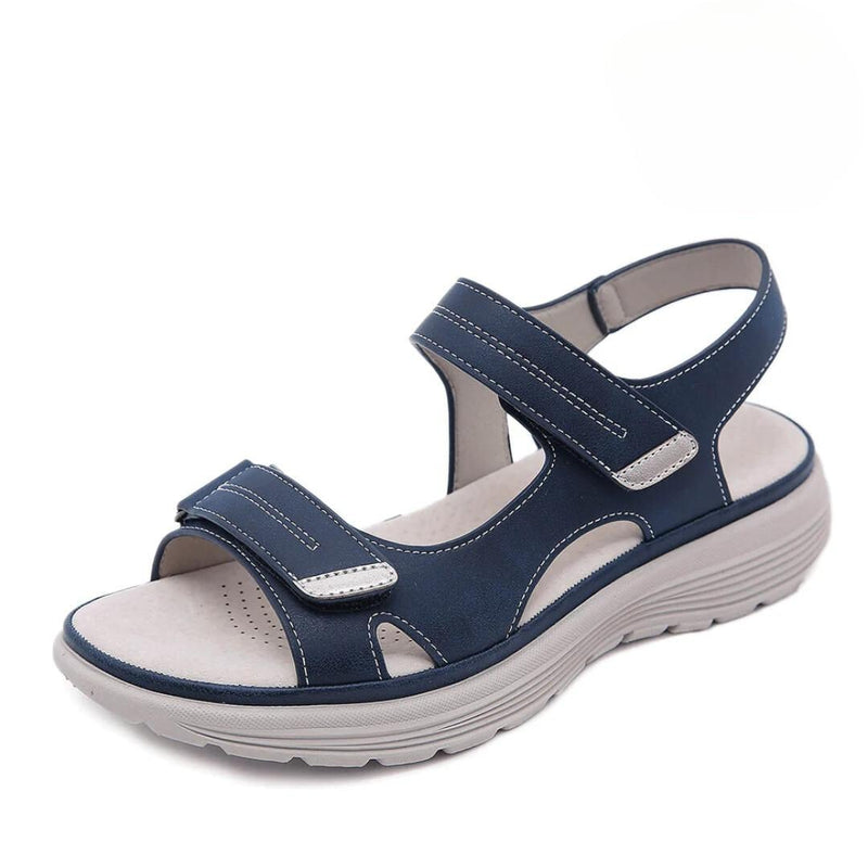 Black orthopedic sandal with wide toe box and cushioned sole on a white background