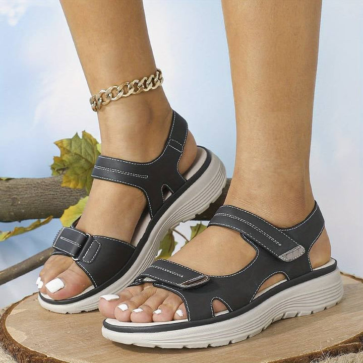 Pair of gray orthopedic sandals shown from above on a neutral background