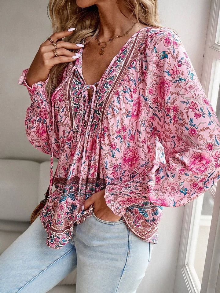 Close-up of delicate floral print detail on a lightweight summer top in pink