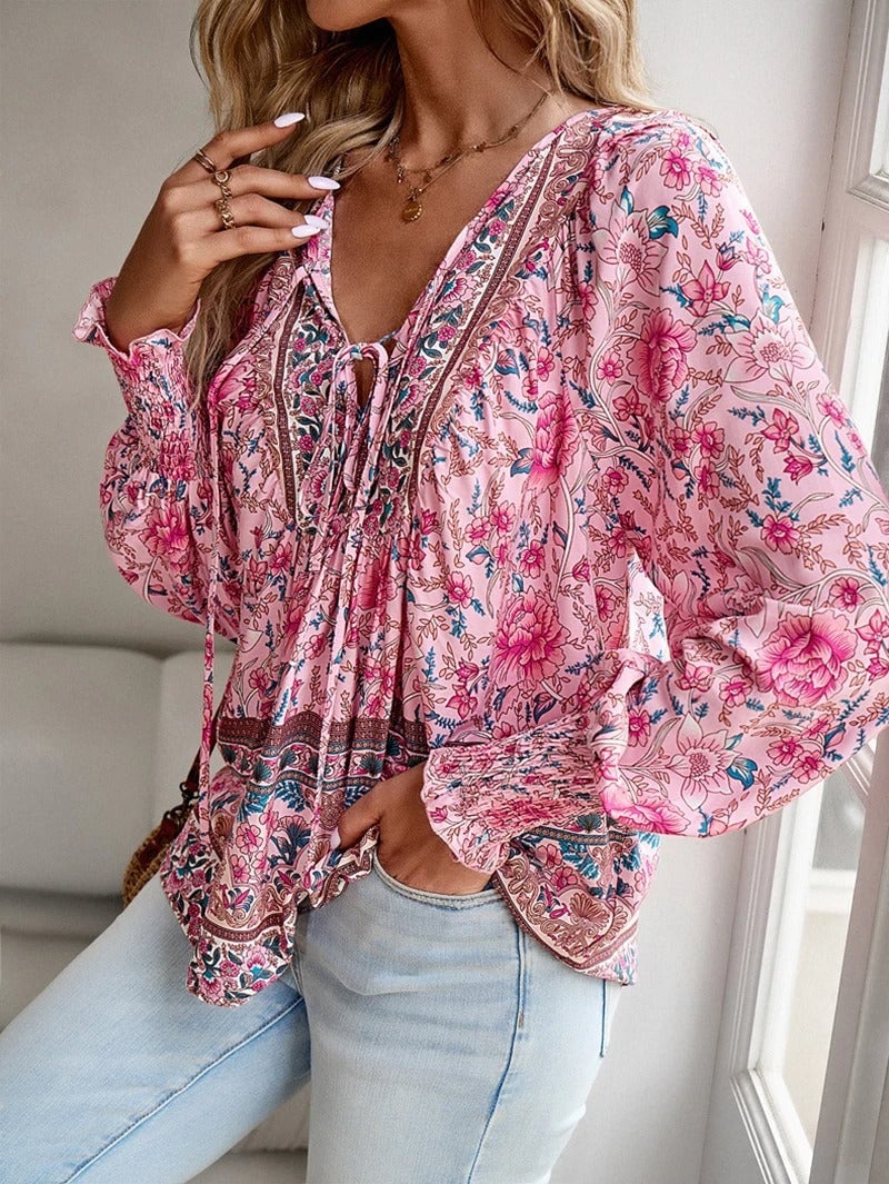 Close-up of delicate floral print detail on a lightweight summer top in pink