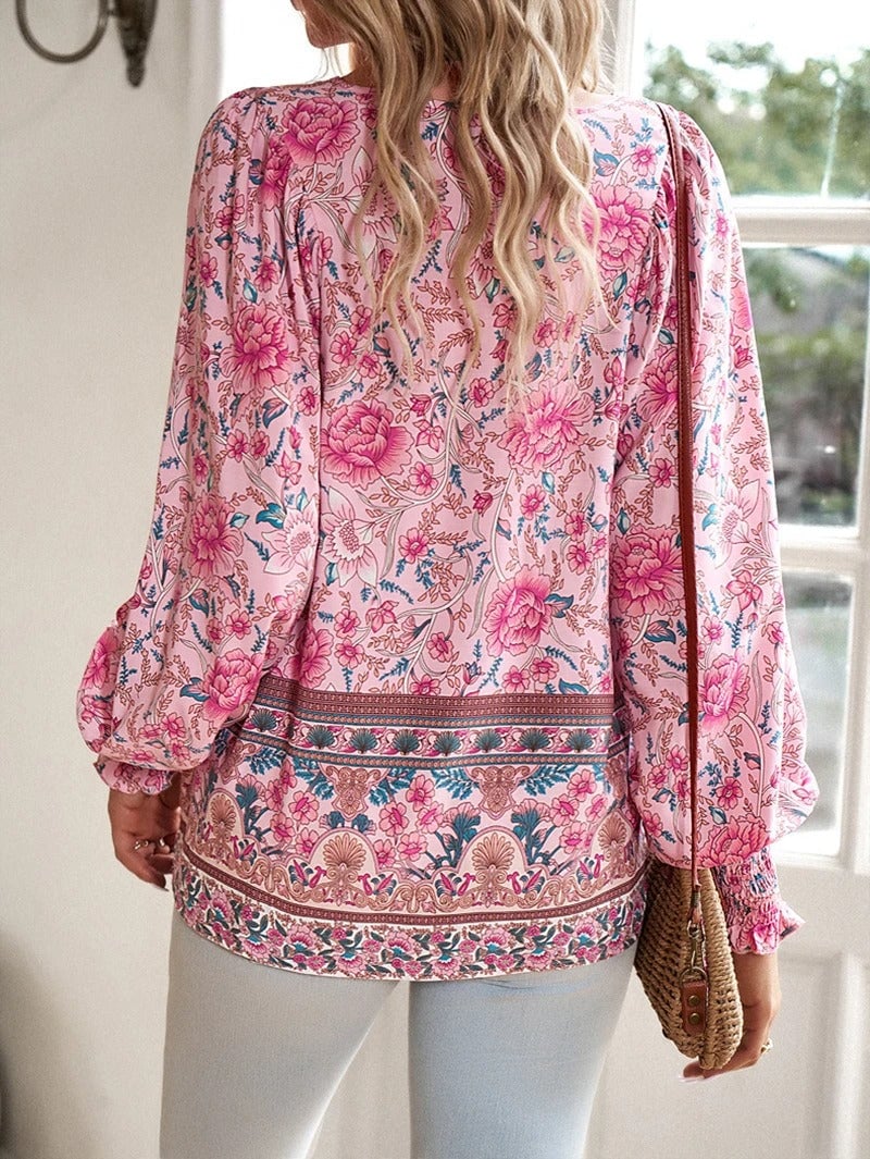 Model wearing a blue summer floral top styled with casual bottoms outdoors