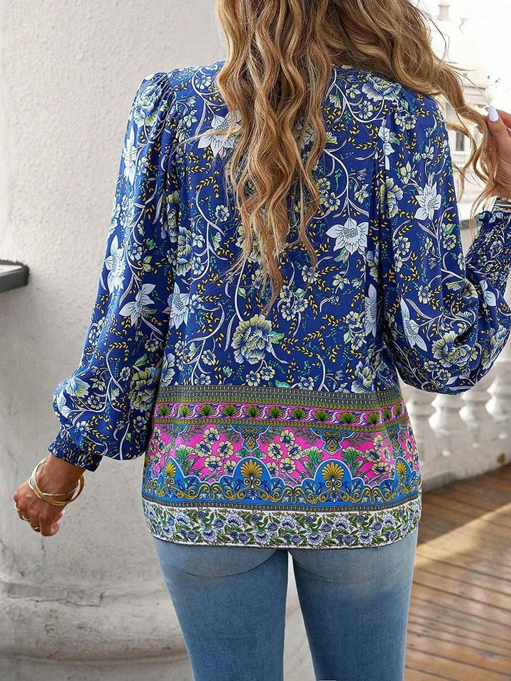 Model smiling in a pink floral top on a sunny day showing the breezy lightweight fabric