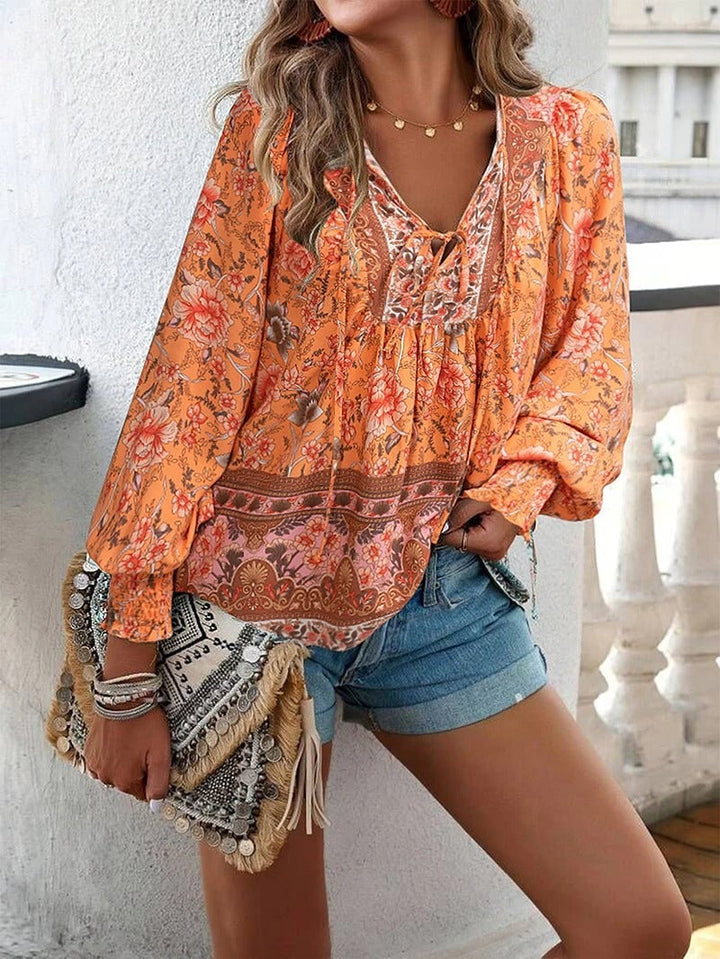 Detail shot of the neckline and floral fabric texture on the lightweight summer top