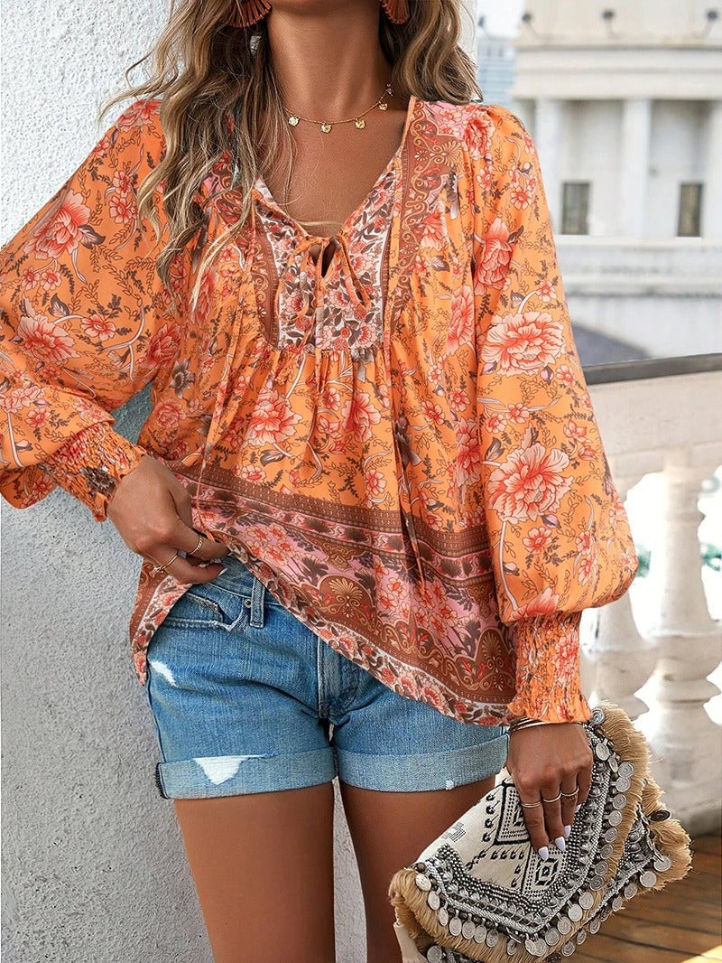 Model in green floral top walking outdoors showing the relaxed carefree fit in motion
