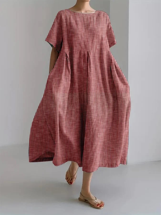 Woman wearing the Bianca long stripe casual dress in blue, featuring a relaxed fit and vertical retro stripe pattern