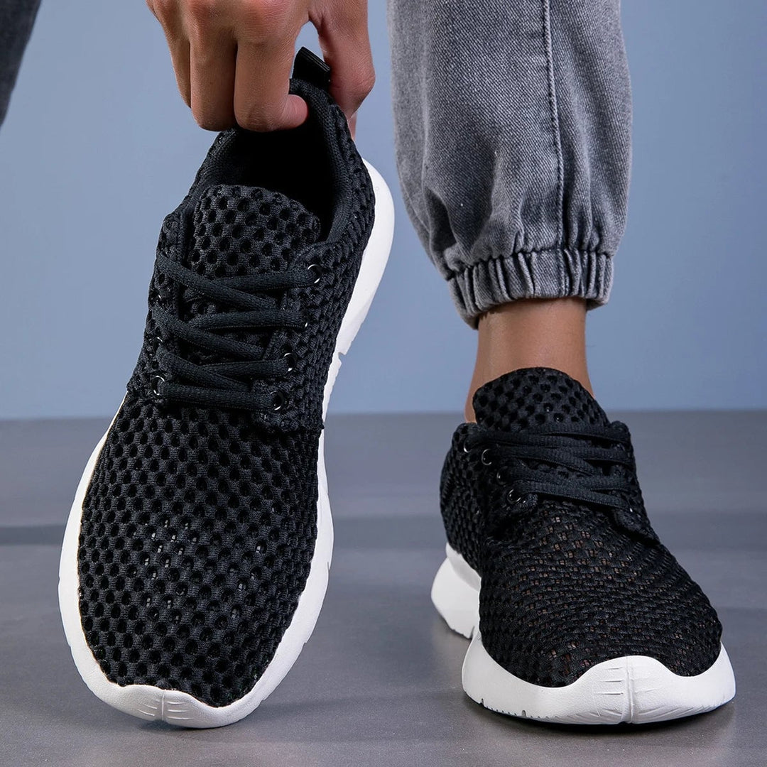Bianca women's black sneaker on foot, lifestyle walking shot