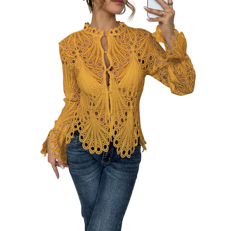 Close-up of intricate hollow cutwork lace detailing and scalloped cuffs on the Bianca blouse