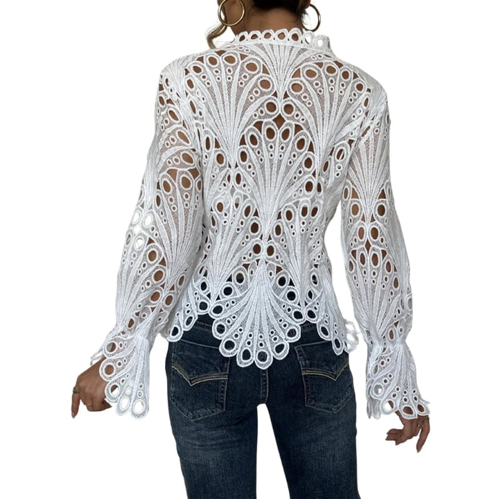 Flat lay of the Bianca lace cutwork blouse in pink showing full scalloped hem and sleeve detail