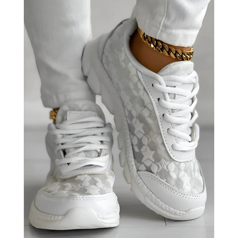 Side profile of white lace overlay chunky sole fashion sneakers showing sculpted platform outsole