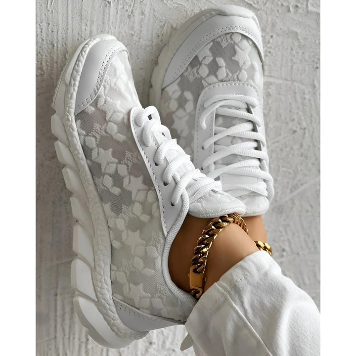 Close-up of delicate tonal floral lace upper detail on white Bianca fashion sneakers