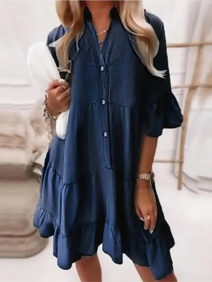 Side view of the Billie chambray ruffle mini dress showing three-tier gathered skirt and elbow-length flared sleeves