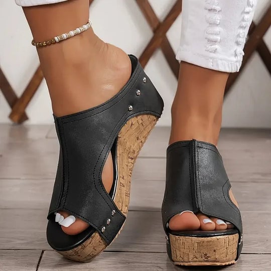 Birdie orthopedic sandal in brown showing cushioned sole and minimalist strap design, front angle