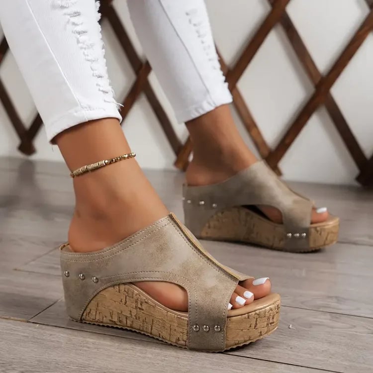 Close-up of Birdie sandal adjustable strap buckle in brown colorway