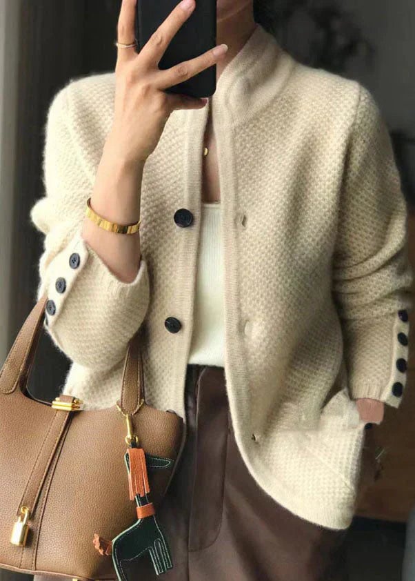 Woman wearing an elegant white button-down cardigan with a flattering silhouette