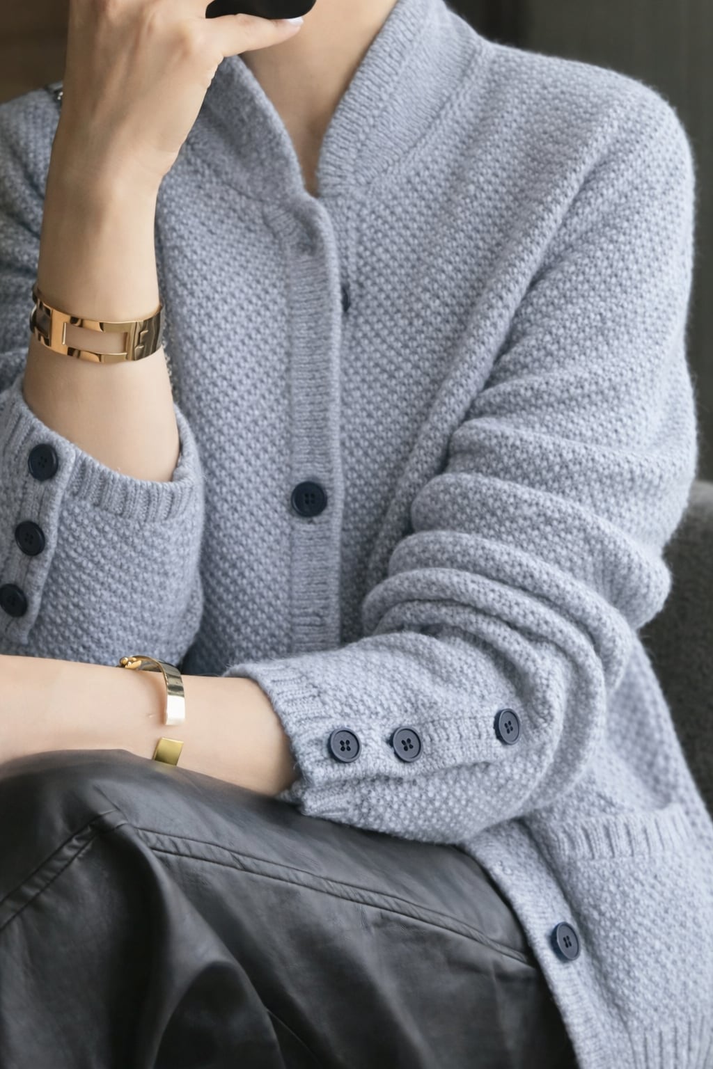 Full-length view of women's classic cardigan available in White, Brown, and Blue