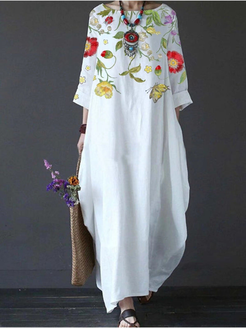 Front view of the Blair white floral maxi dress showing the full-length flowing skirt