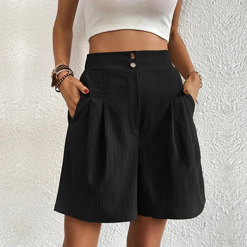 Front view of Blair high waist wide-leg pleated shorts with double gold-tone button waistband in black