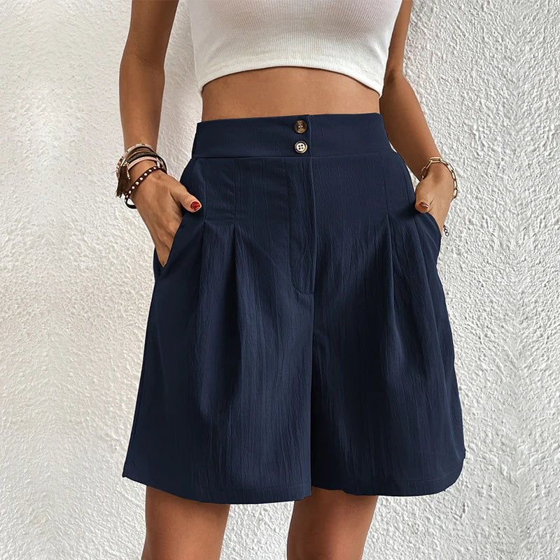 Full-length front view of Blair pleated wide-leg shorts styled with a white cropped top in pink