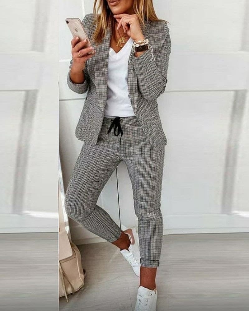 Women's plaid blazer set with slim ankle pants in black, front view on model