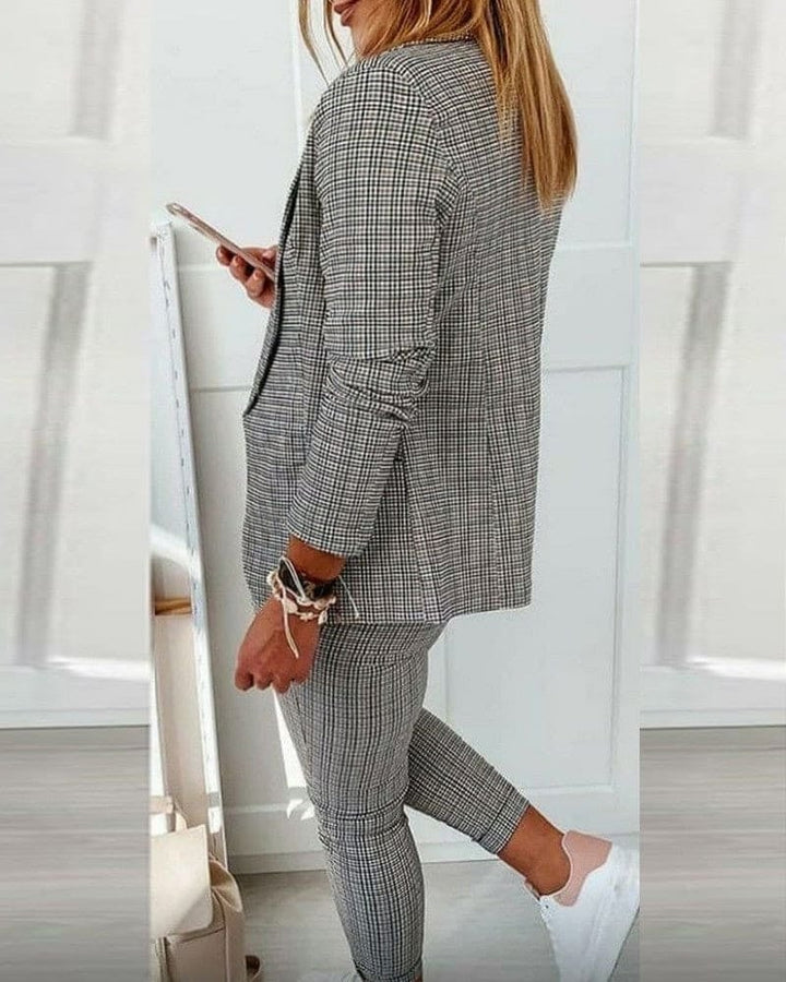 Model styling Blair plaid blazer open over a simple tee with matching pants