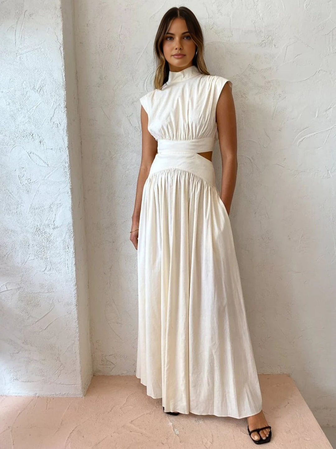 White mock neck cutout maxi dress with gathered skirt and padded shoulders, front view