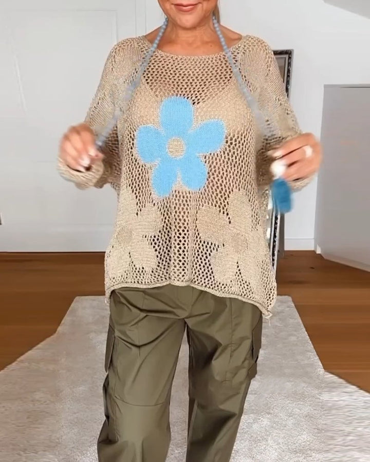 Close-up of the daisy graphic and crochet knit detail on the Bloom top in blue