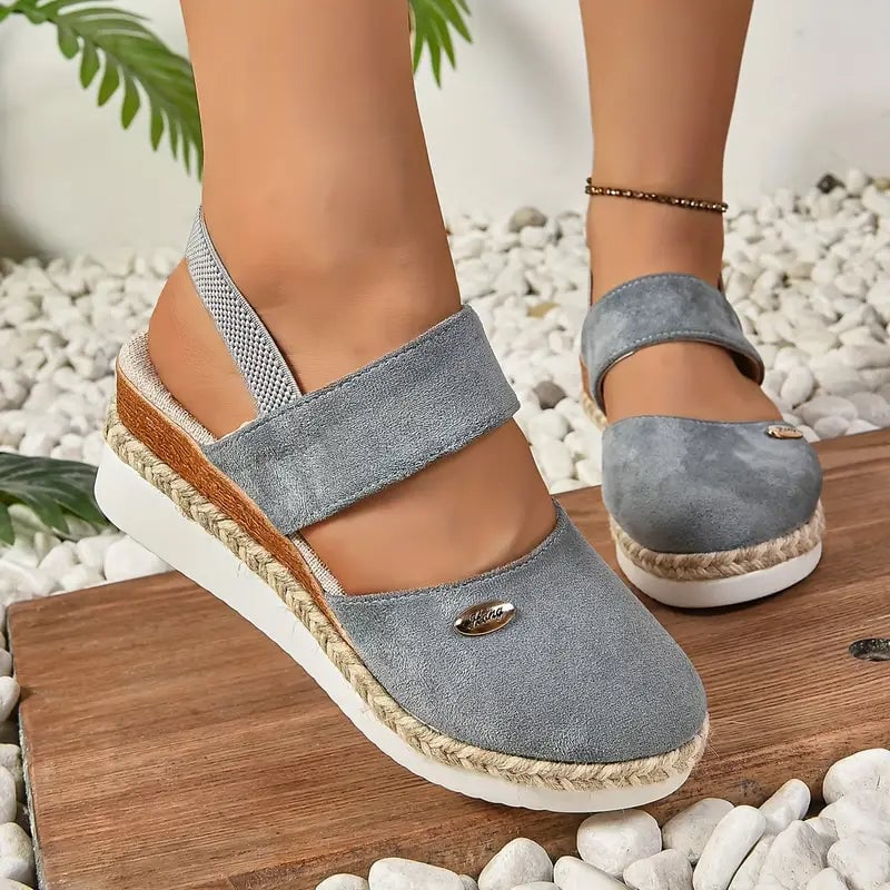 Flat lay of all five Blossom platform sandal color options: white, black, leopard, blue, brown