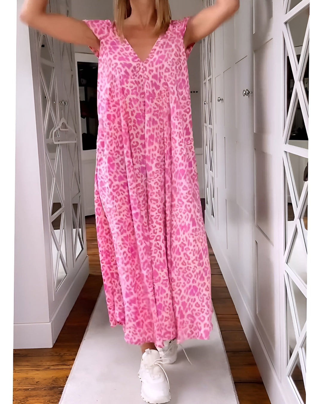 Woman wearing a loose-fit V-neck leopard print maxi dress in pink with short sleeves, full-length front view