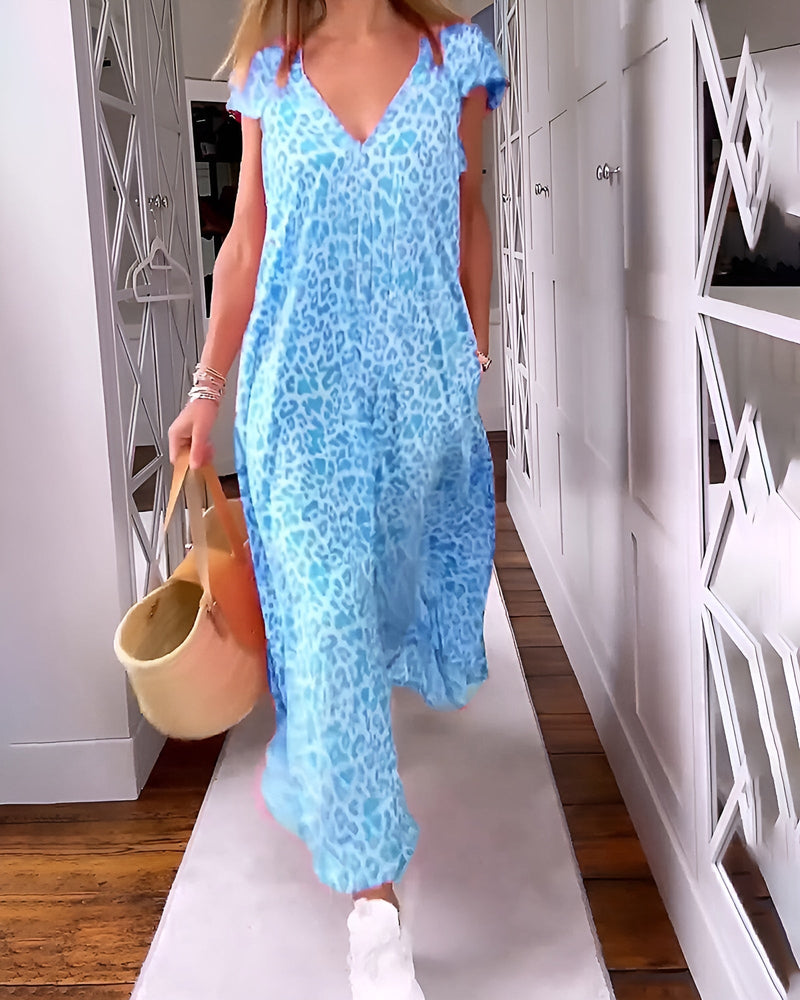 Back view of a woman in a relaxed-fit printed maxi dress showing the flowing silhouette