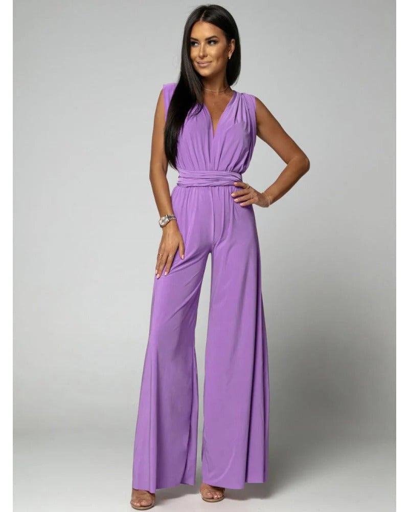 Full-length side view of women's deep V-neck jumpsuit with sweeping wide-leg palazzo pants
