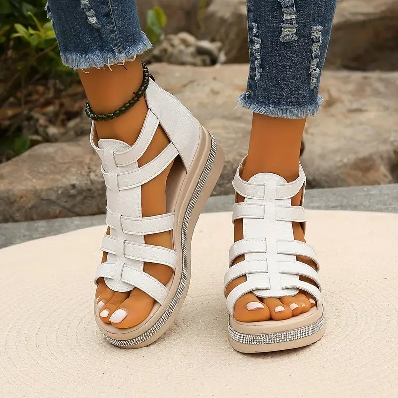 Close-up of Blythe black wedge sandal strap and cushioned sole detail